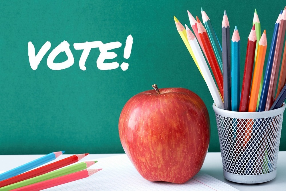 An apple and pencils on a desk