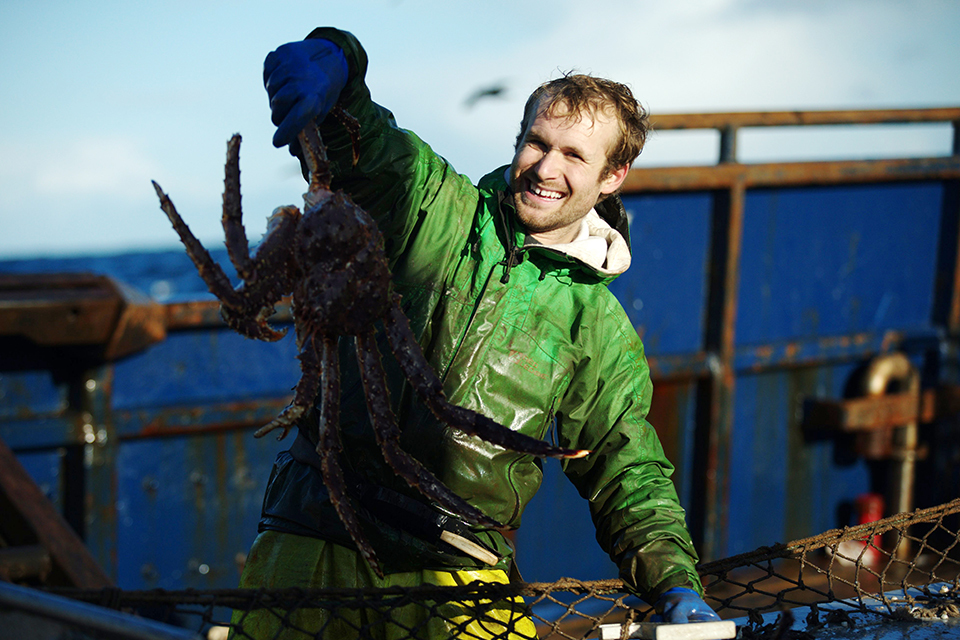 a man holds a crab