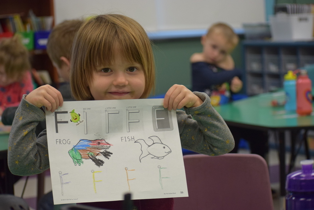 A child holds a drawing