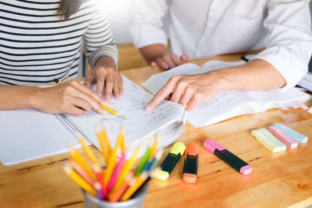 Two people work at a table