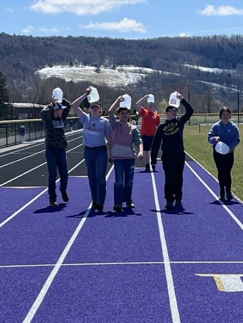 Six students have buckets on thier heads