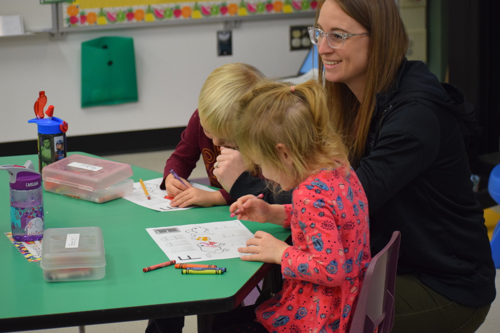 A teacher works with two students
